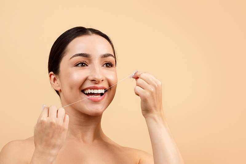 woman flossing her teeth