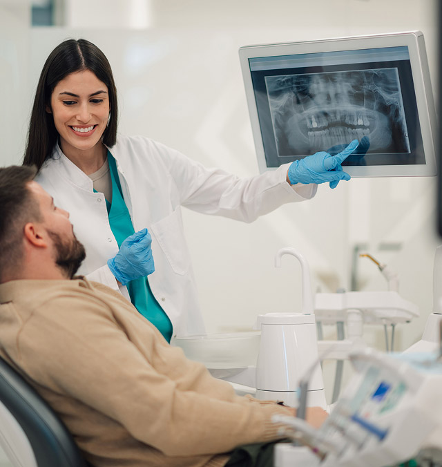 dentist showing x-rays to patient